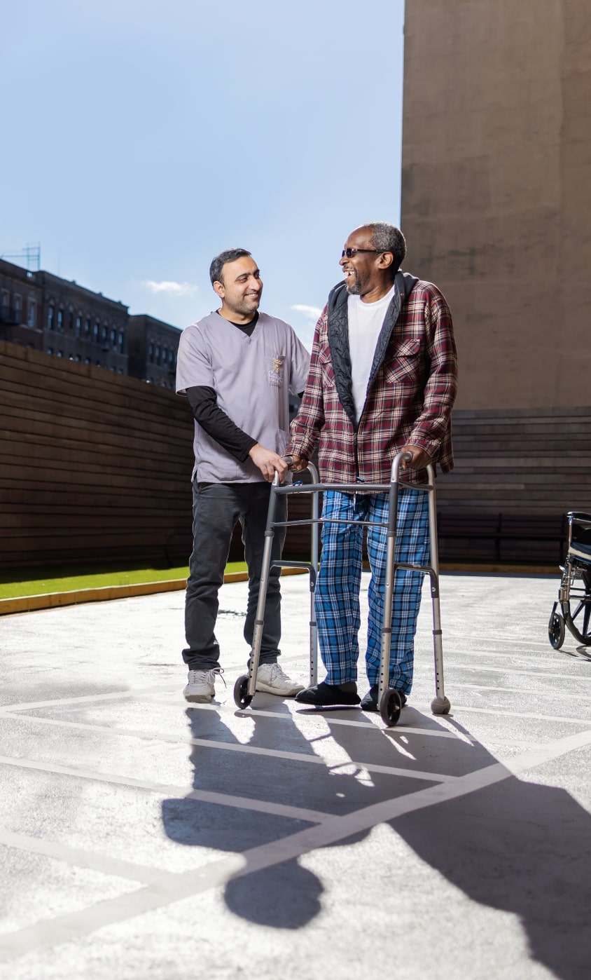 Skilled nurse assisting elderly resident with walker